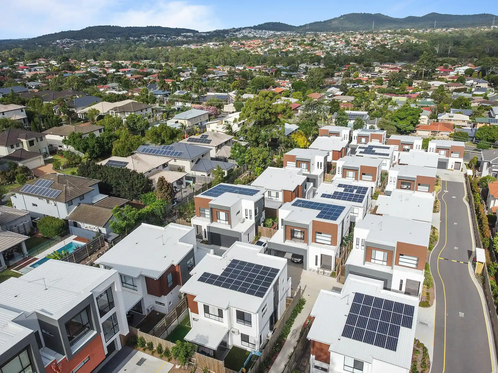 Aerial view of neighbourhood rooftops with solar panels