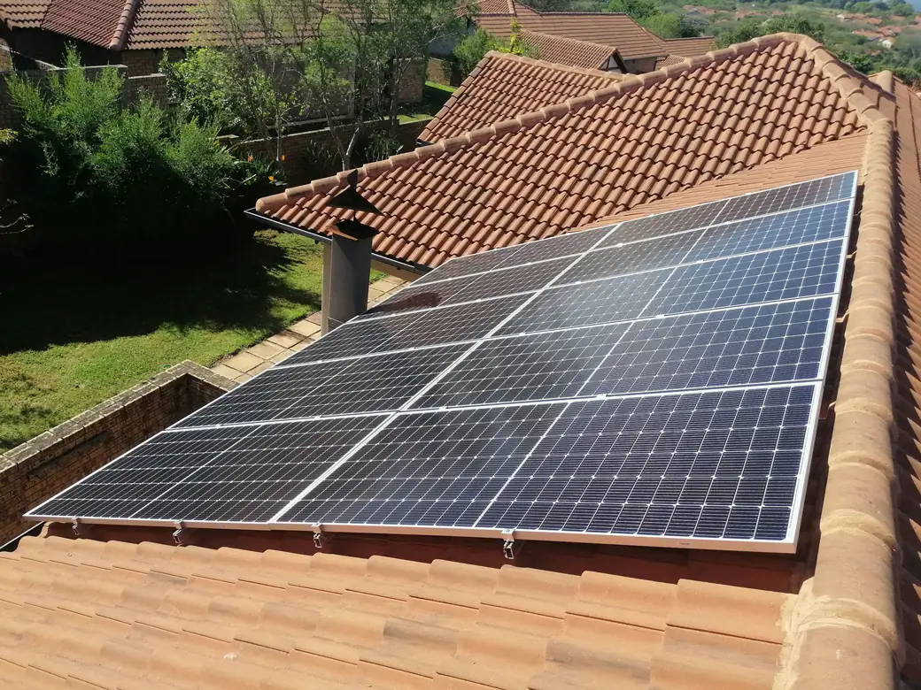 Solar panels mounted on a clay tile roof