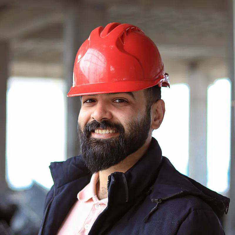 Portrait of Owen Brooks, a smiling man in a red hard hat