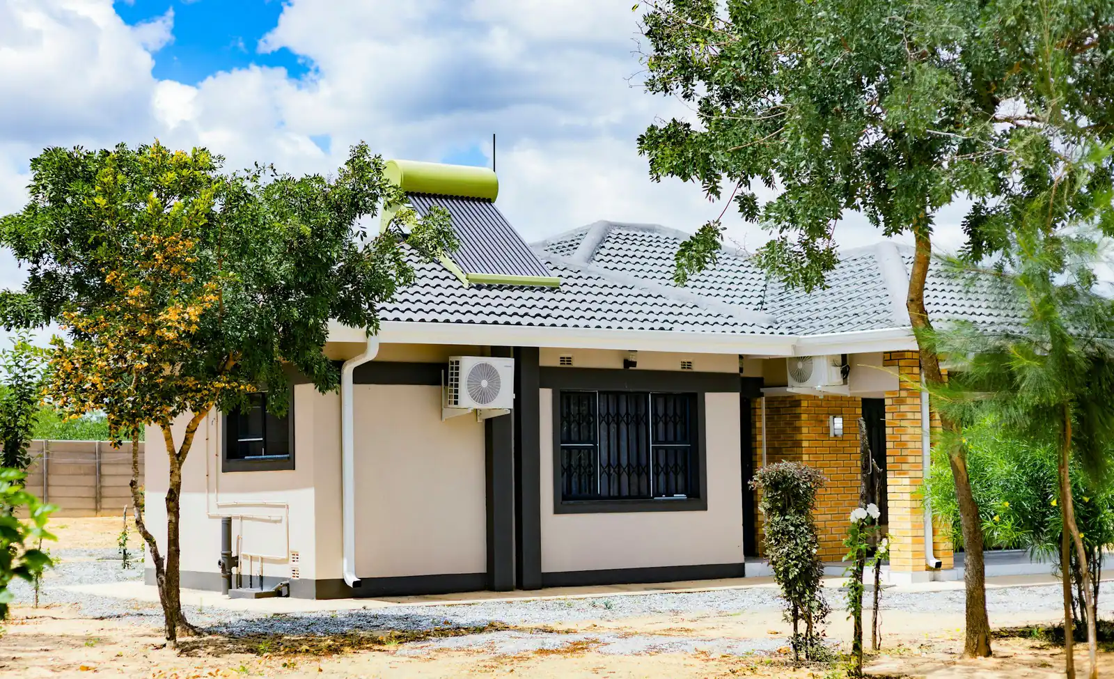 Single-storey house with a solar water heater tank and collector on its roof